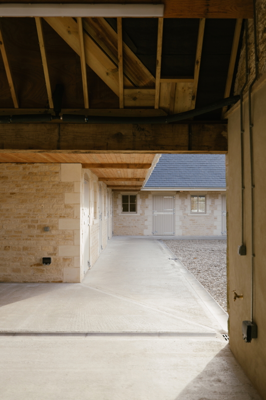 Interior of renovated barn showing exposed beams outward towards courtyard