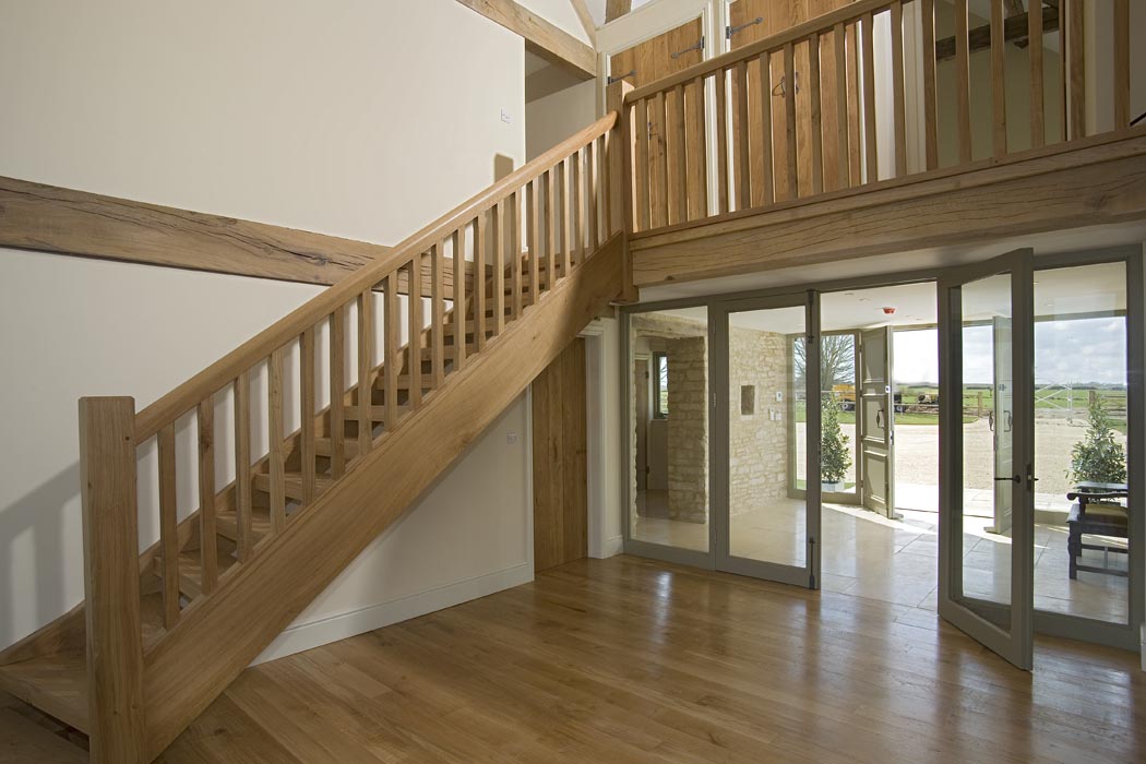 Interior view of the wooden staircase, looking out towards courtyard
