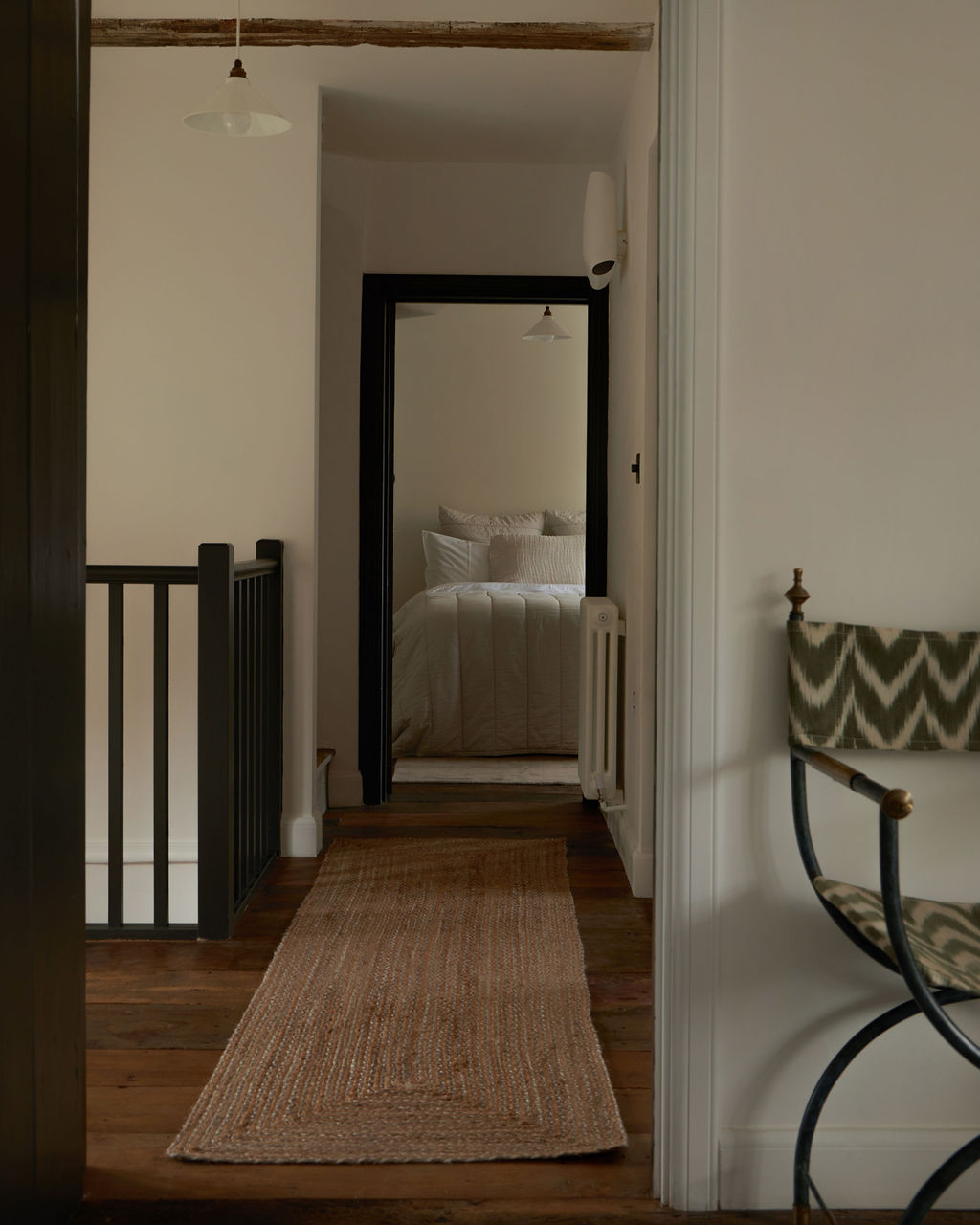 Interior view of upstairs hallway showing renovated wooden flooring