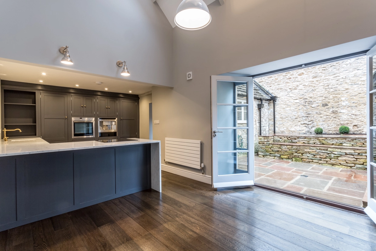 Interior view of the kitchen, with open doors leading to outdoor space
