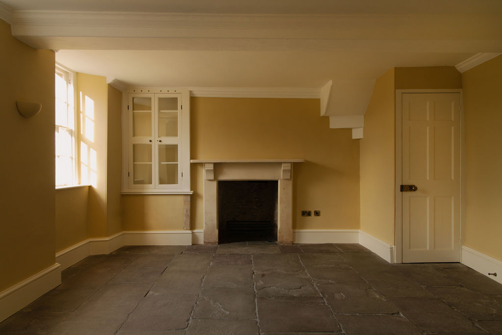 Living area view showing York stone flooring, fireplace, window and door