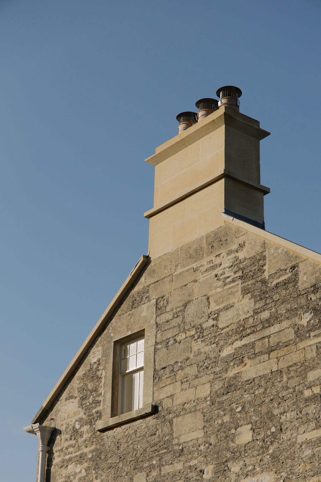 Exterior side view of completed Manor House restoration showing chimney stack