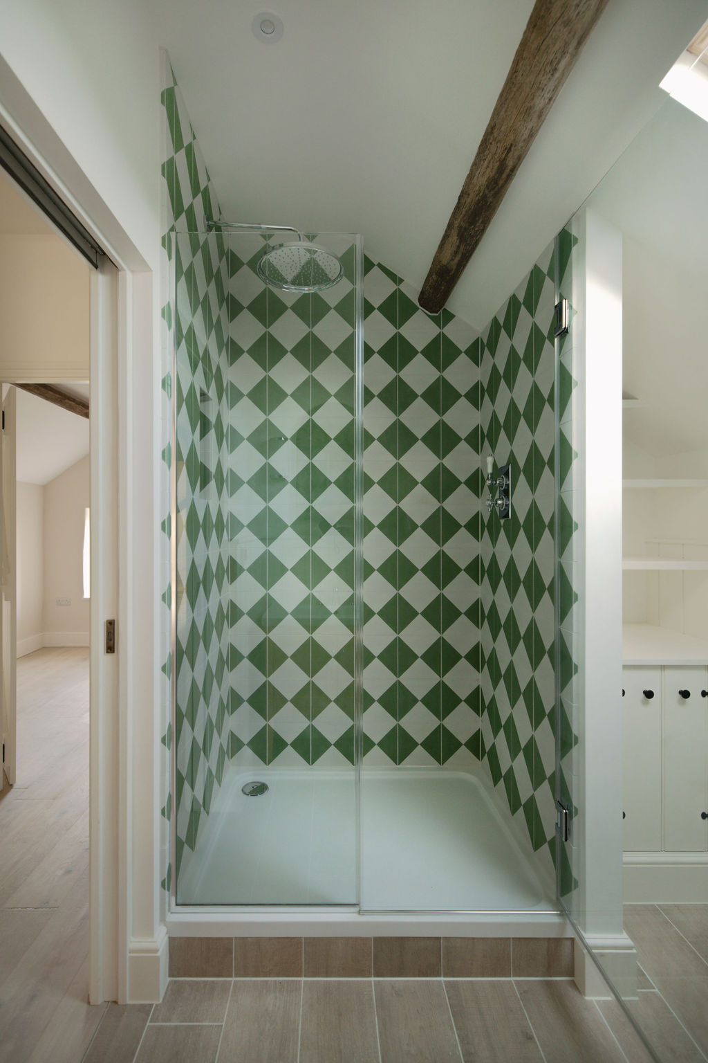 Shower detail with harlequin tiling