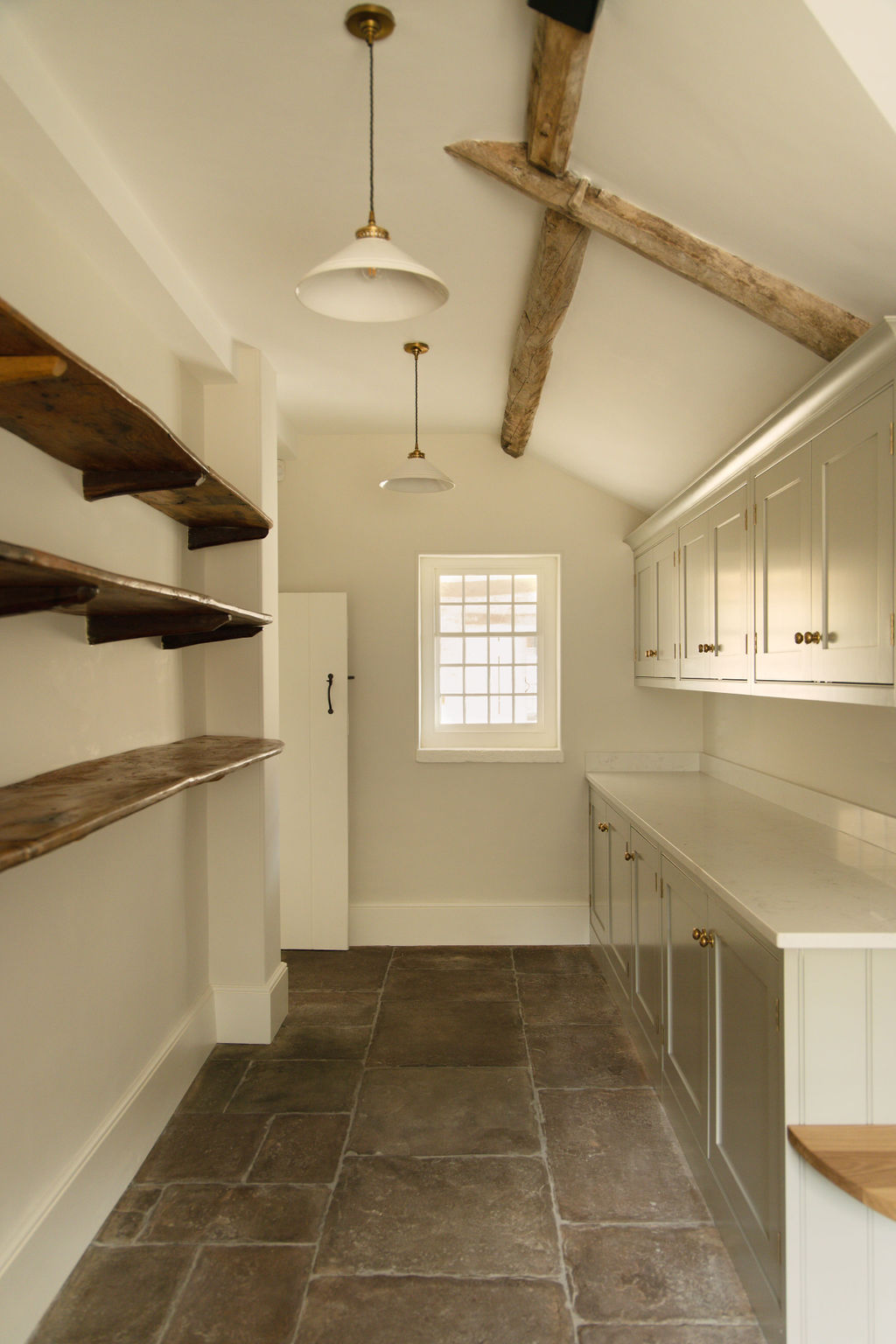Pantry detail showing exposed beams and cabinetry