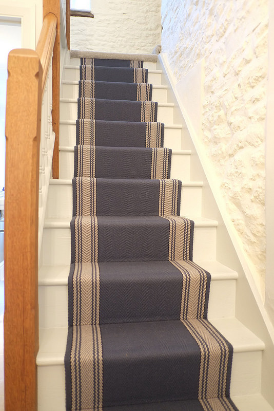 Interior wooden staircase view, with carpet