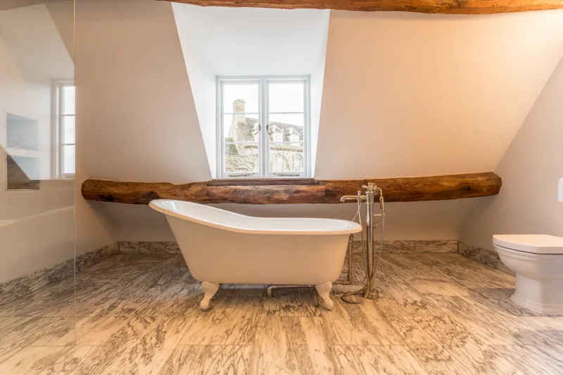 Second bathroom showing freestanding bath and exposed beams