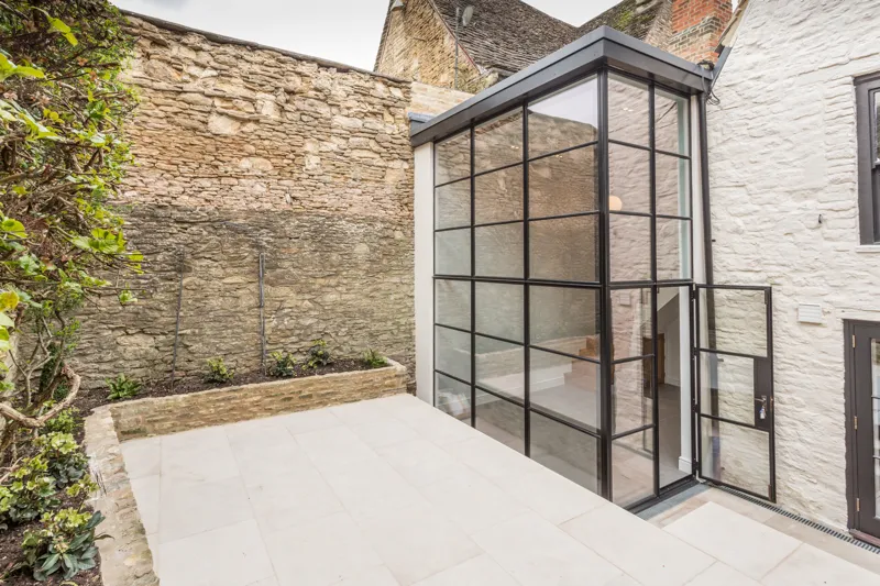 Exterior view of the extension, with Crittall steel windows and door